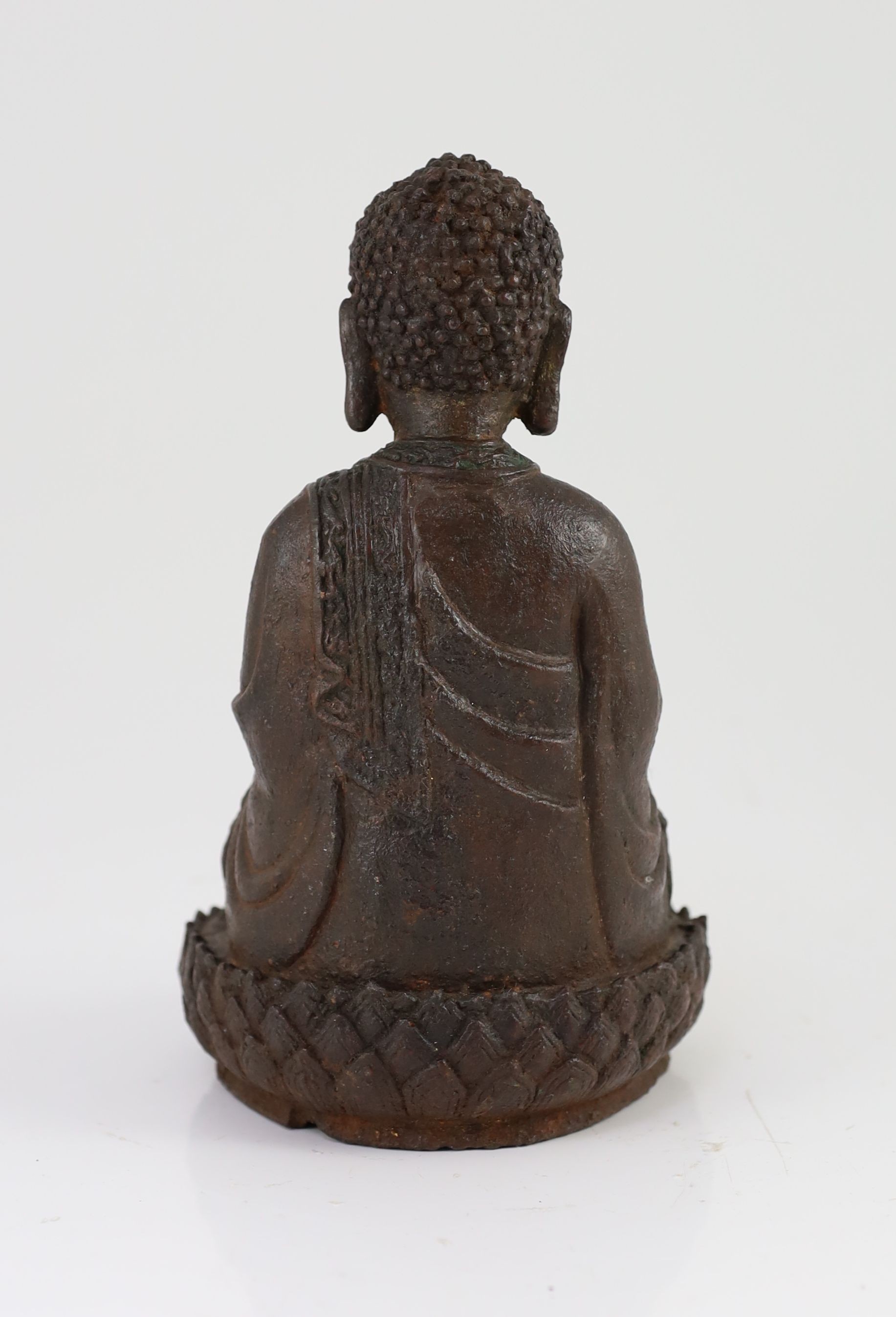 A Chinese Ming cast iron figure of Buddha Shakyamuni, 15th/16th century, 24.5cm high